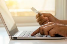 Person paying online by credit card using a personal device.