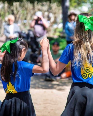 Irish Dancers performing outdoors for a crowd.