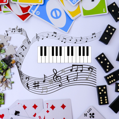 Piano and music notes surrounded by game tiles and cards