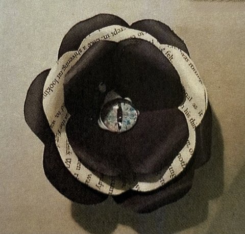 a black paper flower with dragon eye center