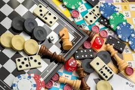 image of various game pieces laid flat - chess pieces, dominoes, chips, dice, etc.